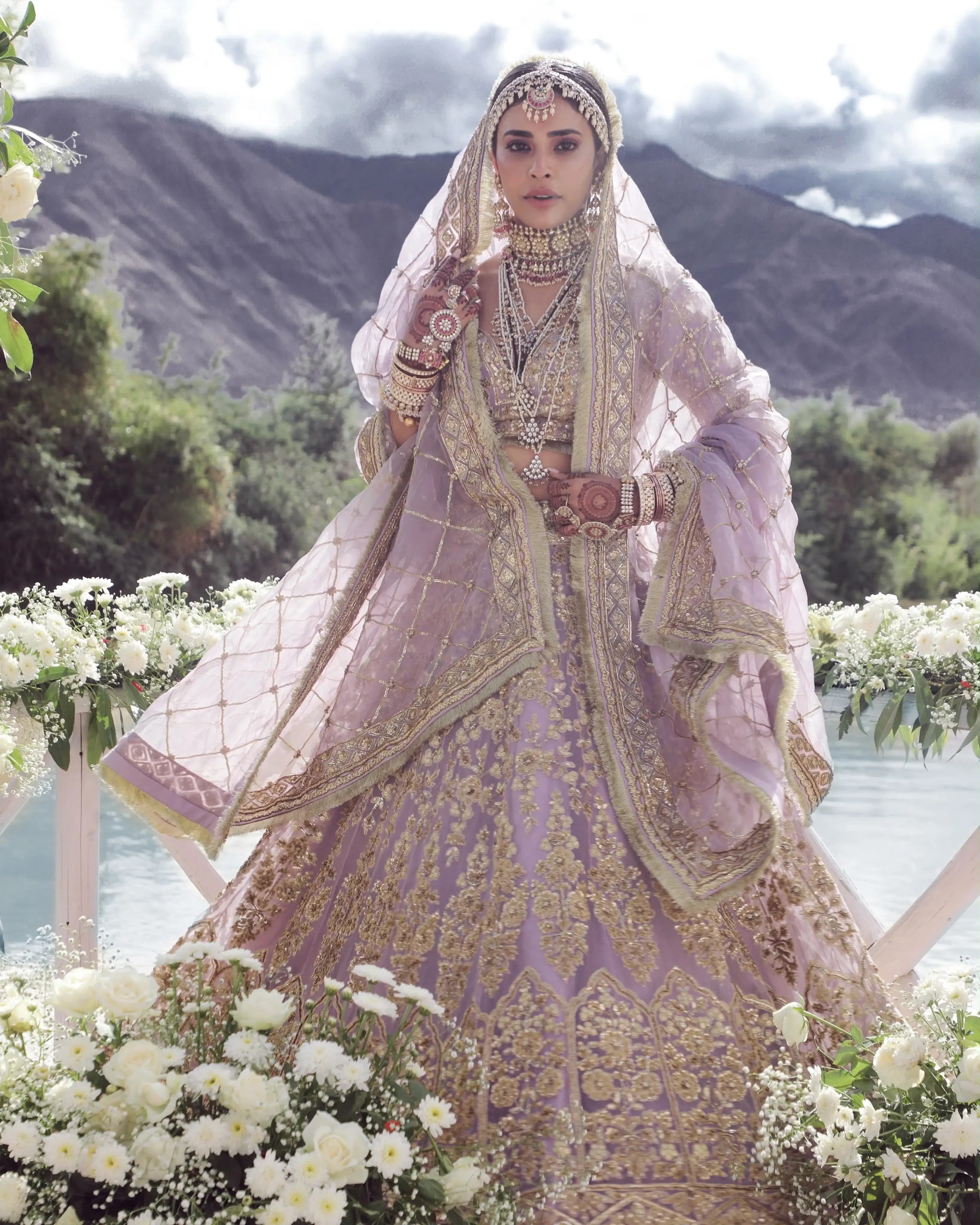 Bridal portrait in a lilac lehenga among white flowers