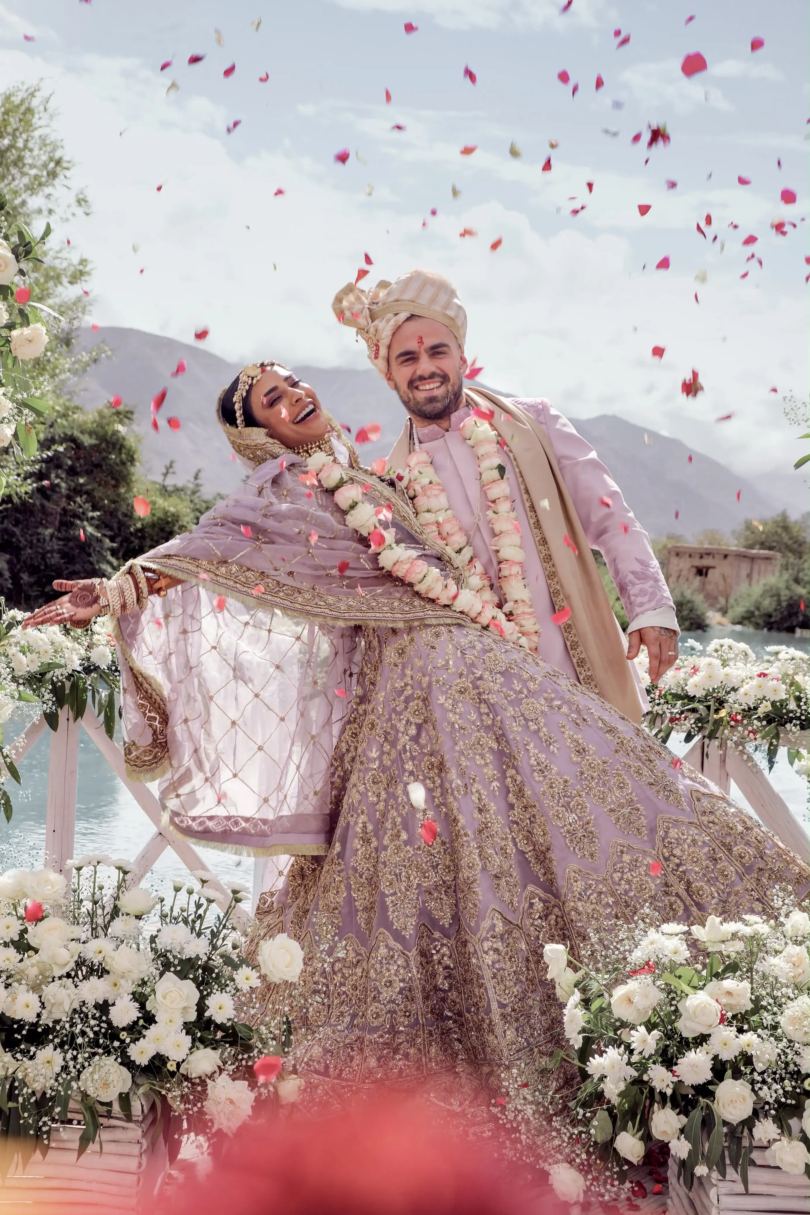 Couple celebrating under a shower of rose petals