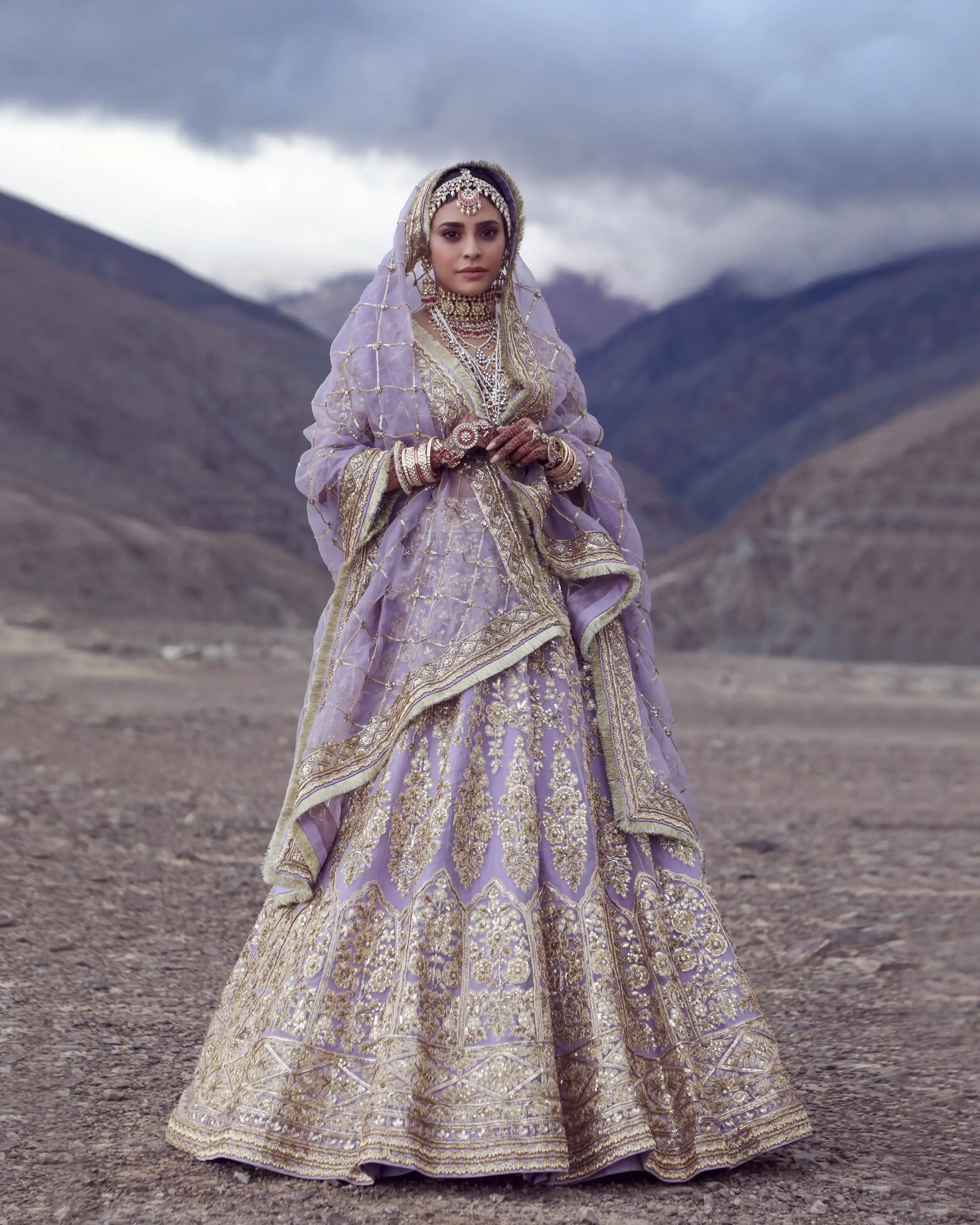 Bride in a lilac lehenga against the mountain desert